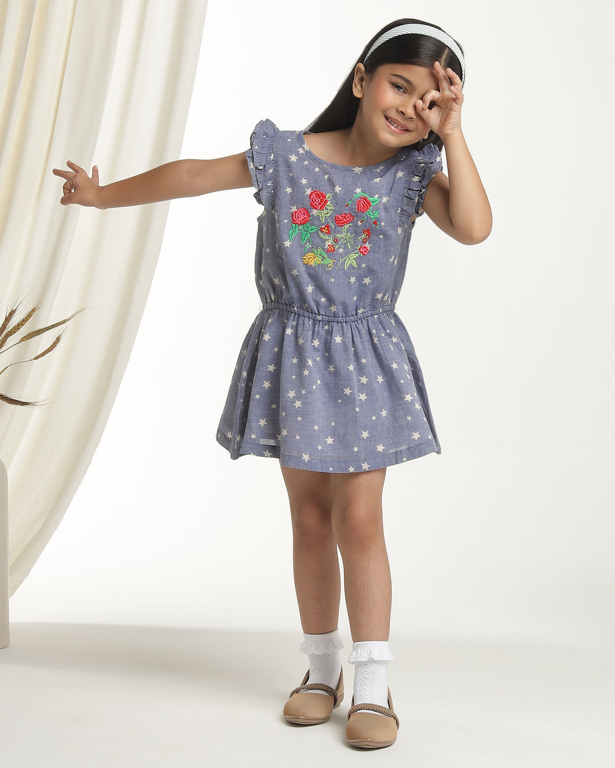 Navy blue girls printed sleeveless dress with gathered waist and flared skirt