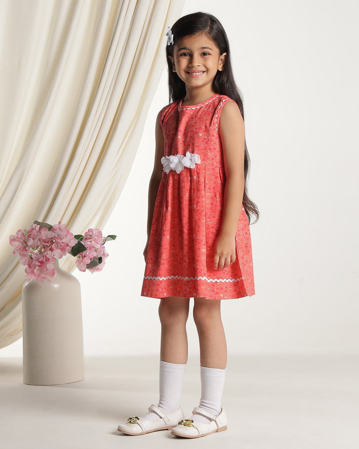 Coral girls sleeveless fit and flare dress with floral embroidery and flared hem