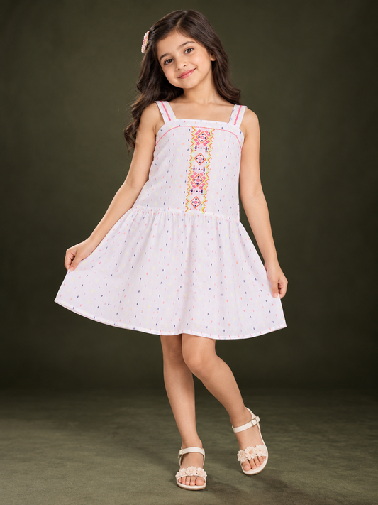 White girls sleeveless top with peach floral embroidery and ruffle detailing