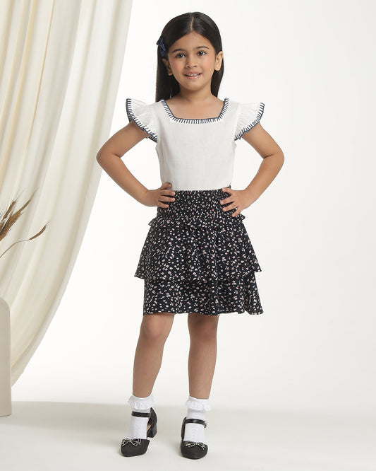Black floral printed girls flared skirt with layered ruffle detailing and elasticated waist