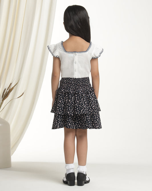 Black floral printed girls flared skirt with layered ruffle detailing and elasticated waist